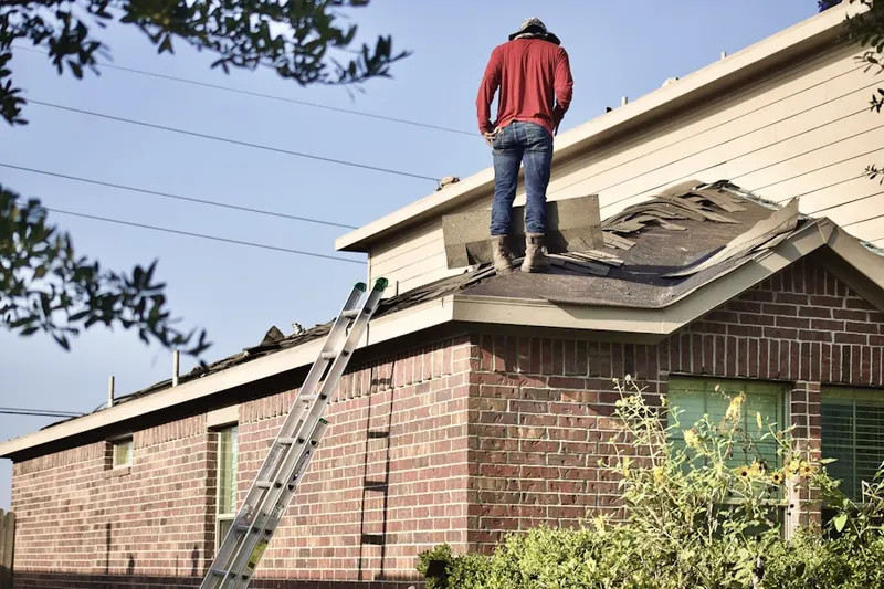 Professional roofer working on a residential roof in Greenlawn